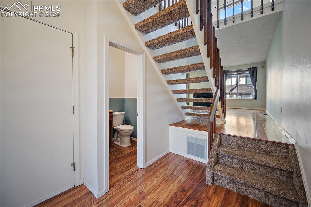 Image 4 of 31: Stairs with wood finished floors and baseboards