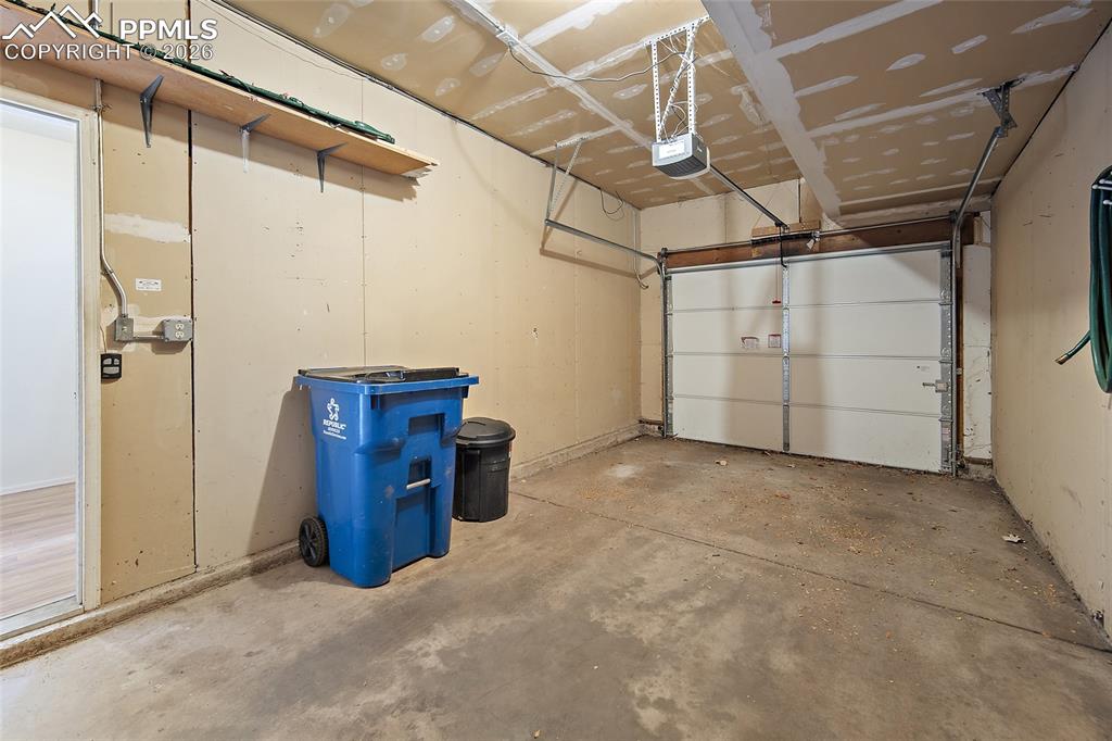 Image 6 of 31: Garage with a garage door opener