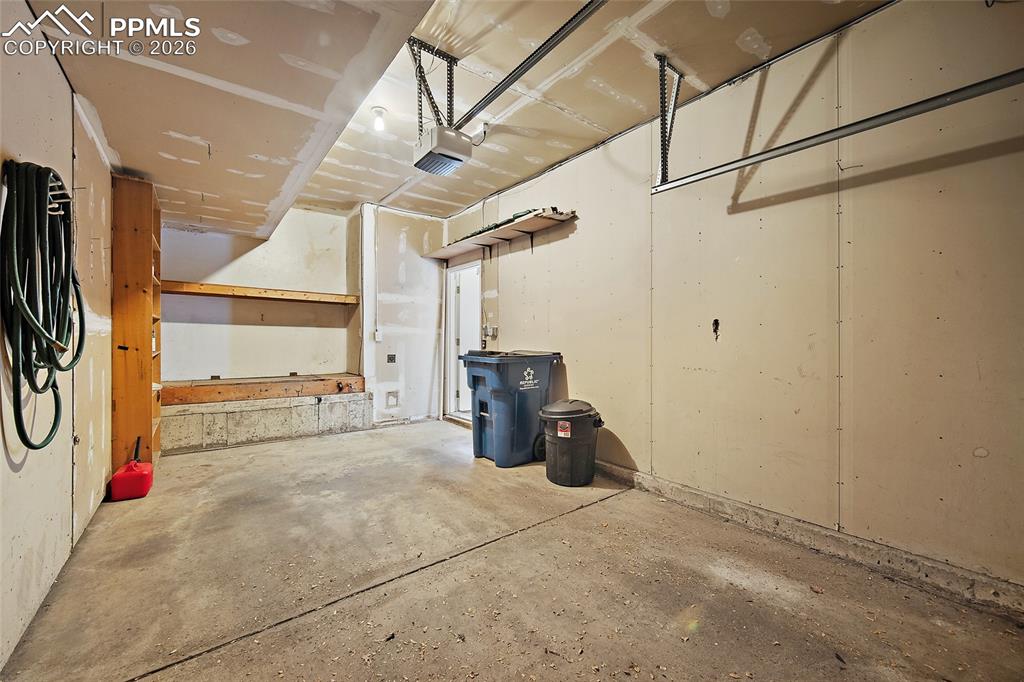 Image 7 of 31: Garage with a garage door opener