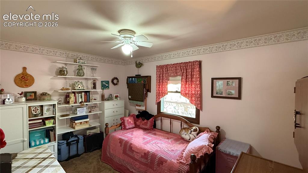 Image 12 of 38: Room featuring light pink walls and a decorative wallpaper border