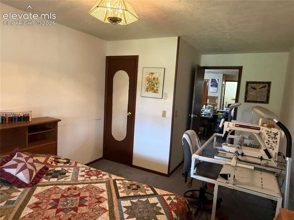 Image 17 of 38: Interior room featuring neutral wall paint, gray carpet flooring, and a dec