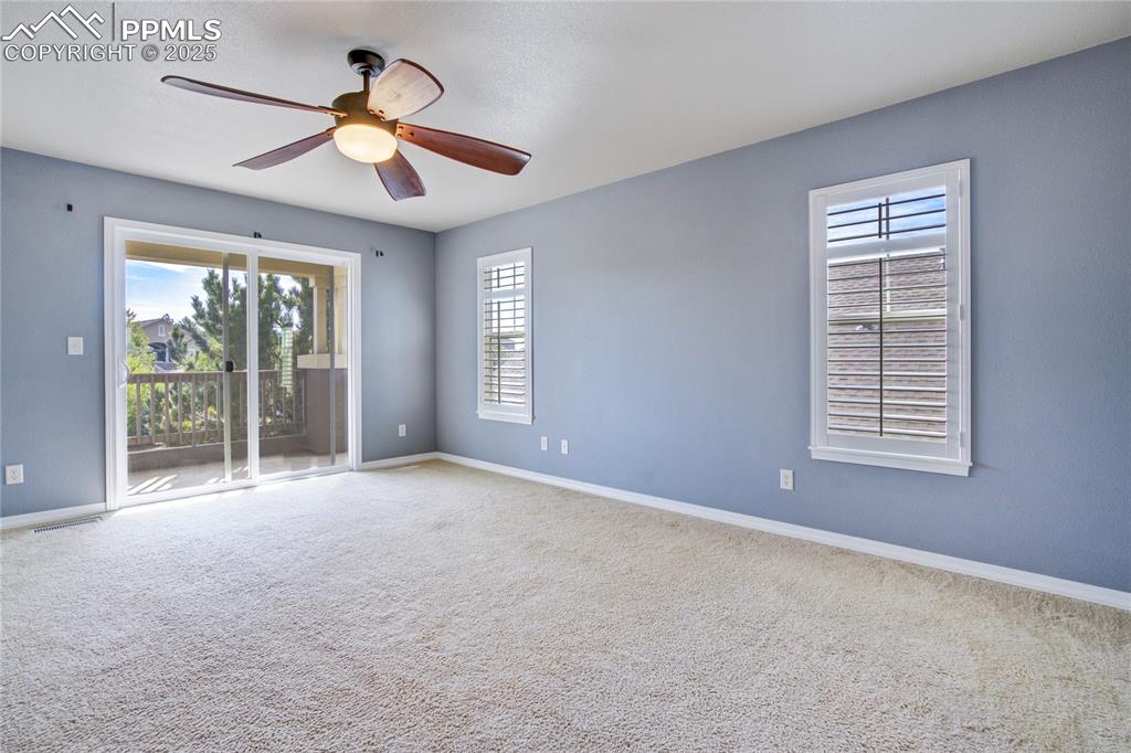 Image 19 of 50: Spare room with healthy amount of natural light, carpet flooring, and ceili