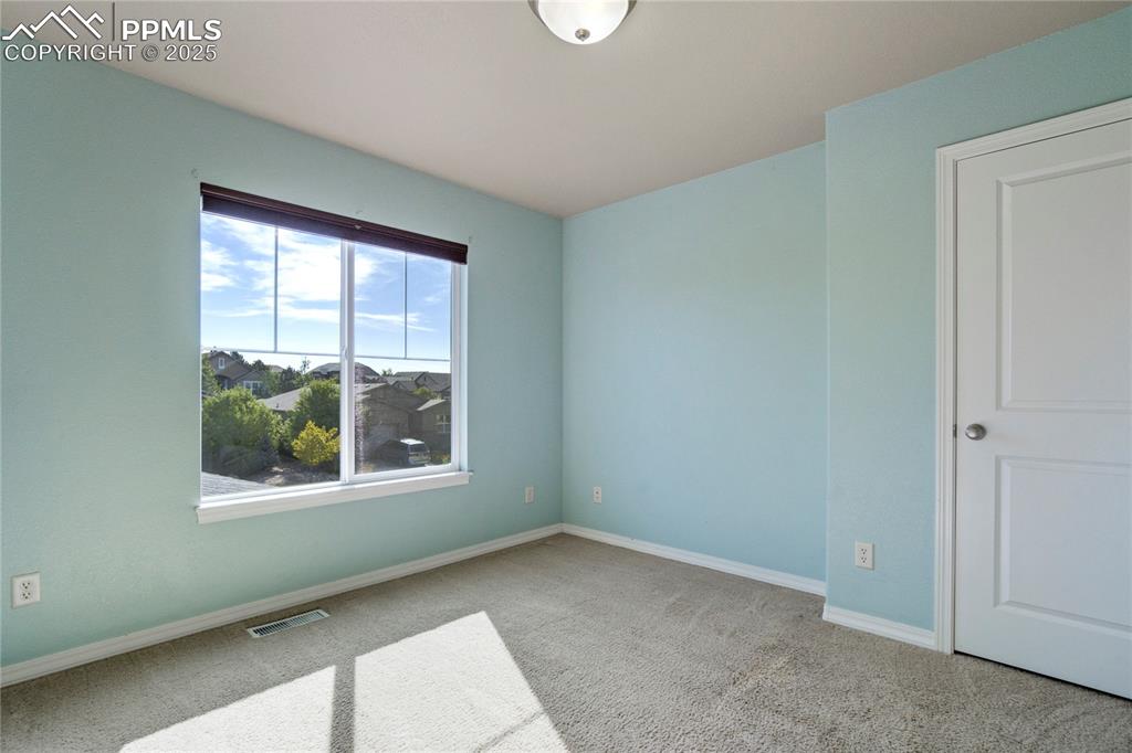 Image 30 of 50: Spare room with light carpet and baseboards