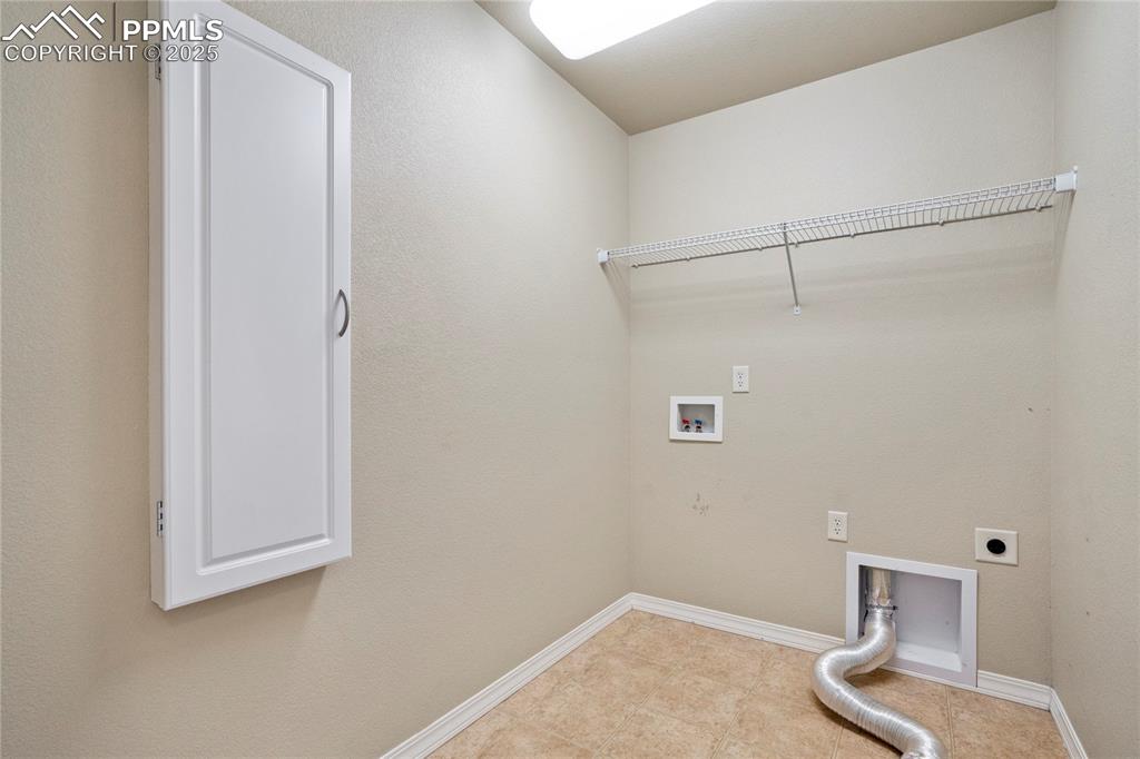 Image 32 of 50: Laundry room featuring washer hookup, electric dryer hookup, and light tile