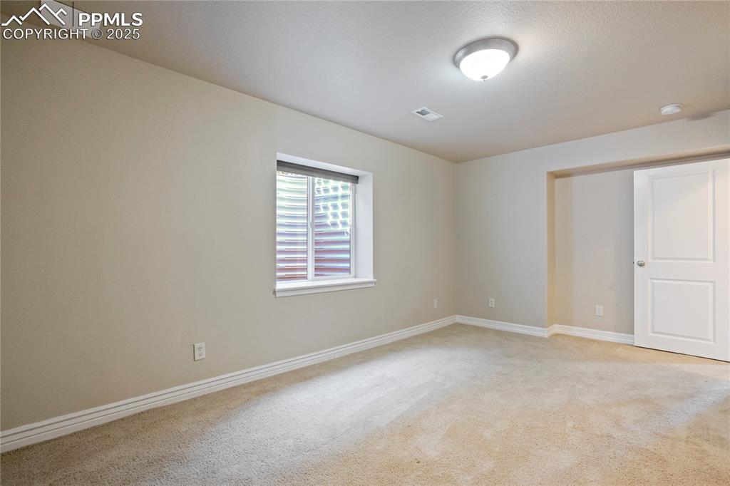 Image 38 of 50: Unfurnished bedroom featuring light carpet and baseboards