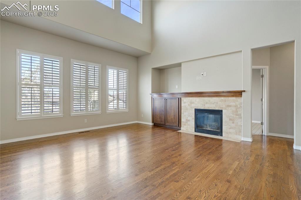 Image 46 of 50: Unfurnished living room featuring a fireplace with flush hearth, wood finis