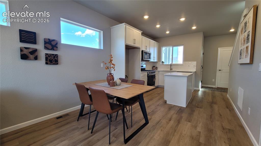 Image 11 of 41: Dining area with LVP flooring, ready to host a dinner party!