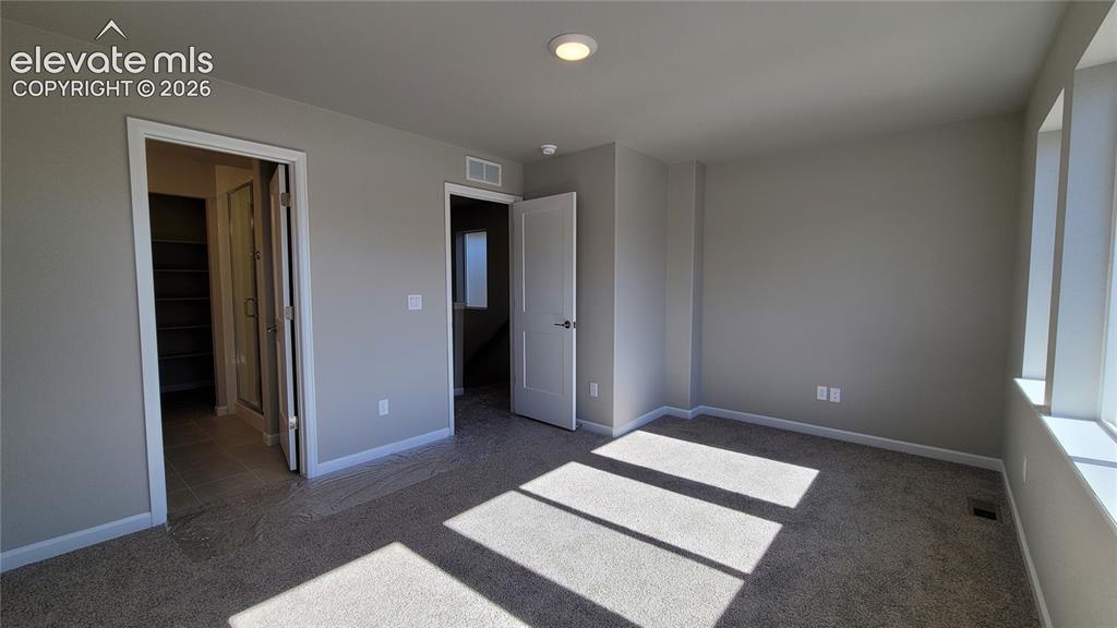 Image 12 of 25: Primary Suite is accompanied with a plush bathroom and walk-in closet!
