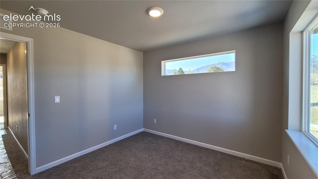 Image 16 of 25: Primary Closet with Wood Shelving and Rods!