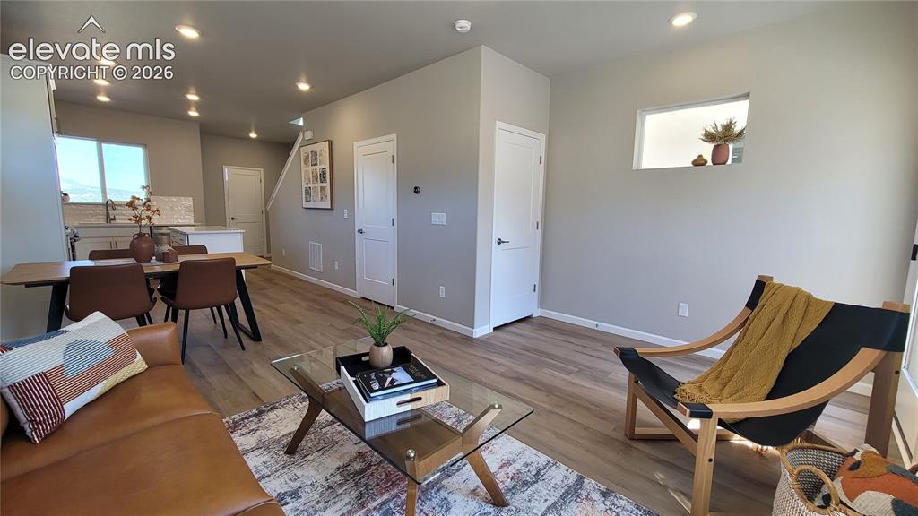 Image 16 of 41: Living room with LVP flooring, abundance of natural light, walk out to back