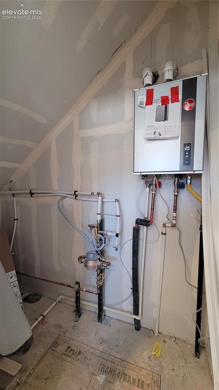 Image 34 of 41: Utility closet located on main level with a tankless water heater! 