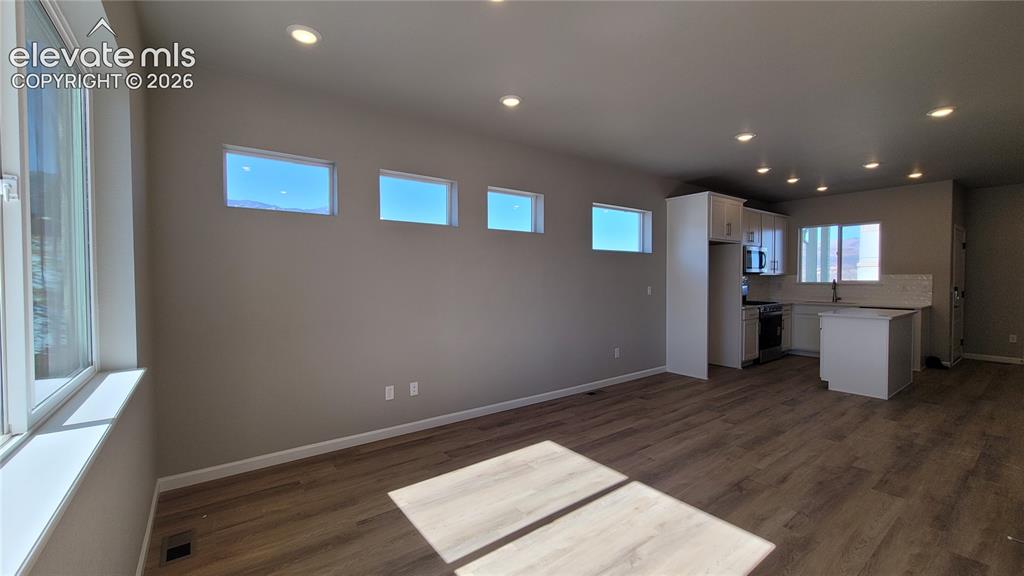 Image 7 of 25: Living Room with LVP flooring, plenty of natural light, LED lighting, and w