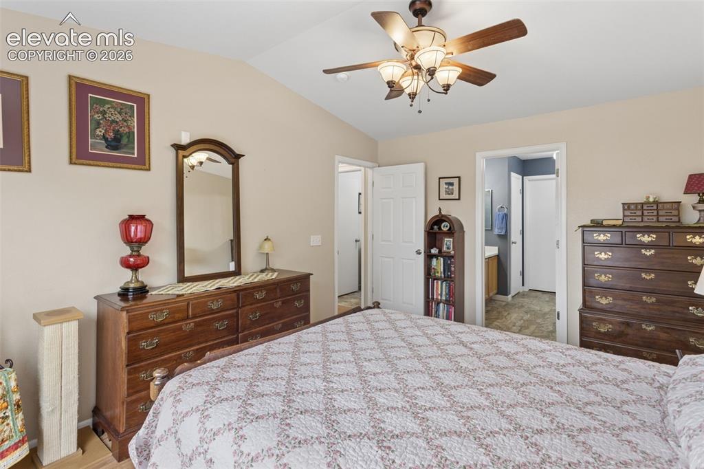 Image 15 of 32: Vaulted ceiling, ceiling fan with integrated lighting, wood-finish flooring