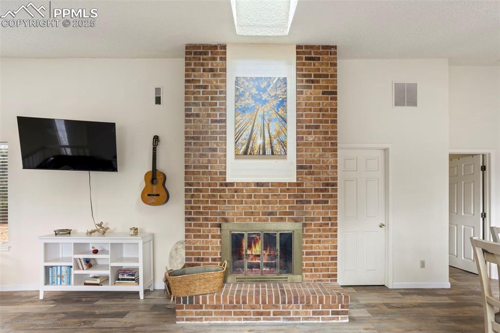 Image 7 of 24: Wood Fireplace converted to gas.