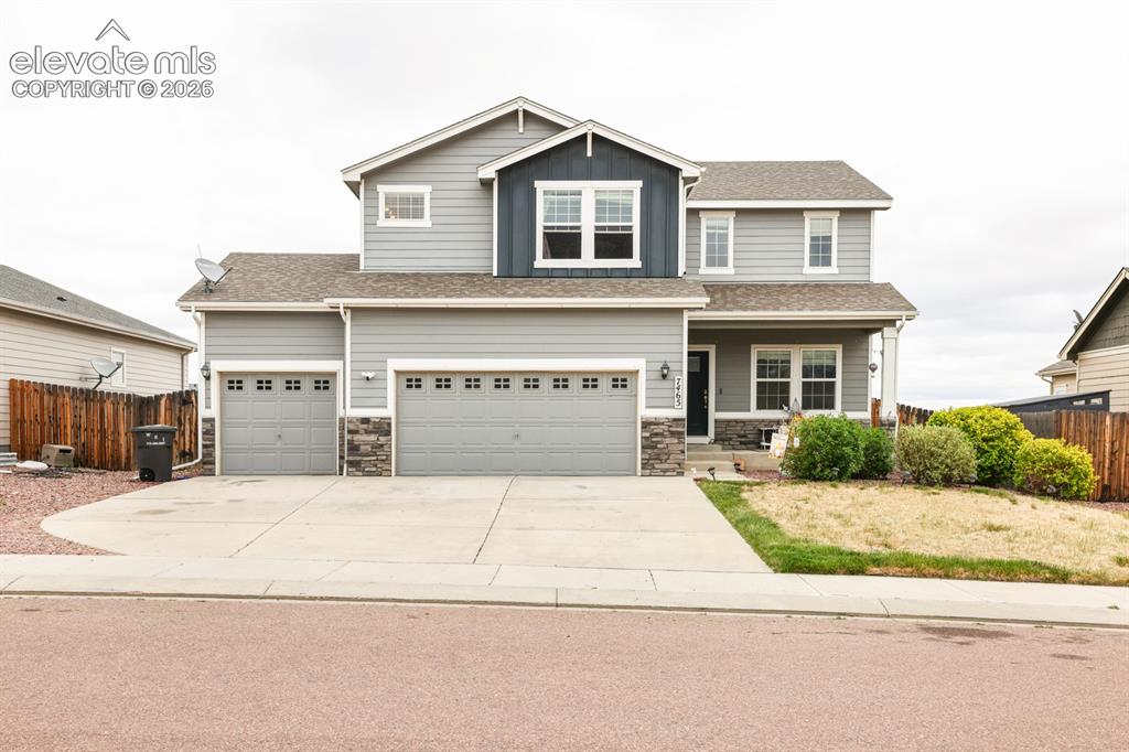 Image 1 of 44: Two-story residence featuring light gray siding with stone accents and a co