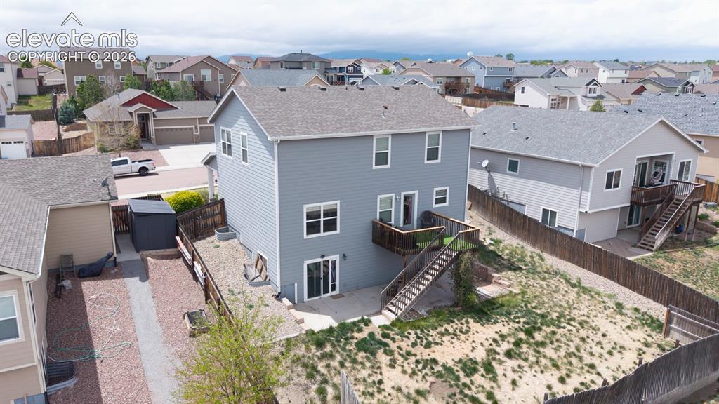 Image 15 of 44: Multi-story residence featuring light gray siding and white trim