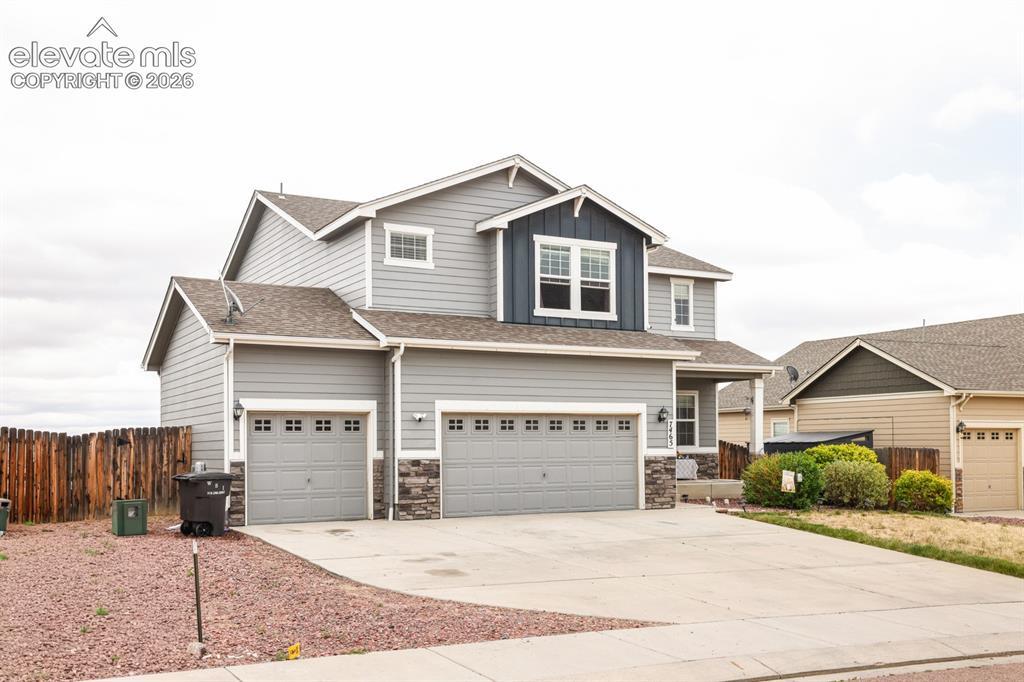 Image 2 of 44: Contemporary two-story residence featuring light gray siding and a contrast