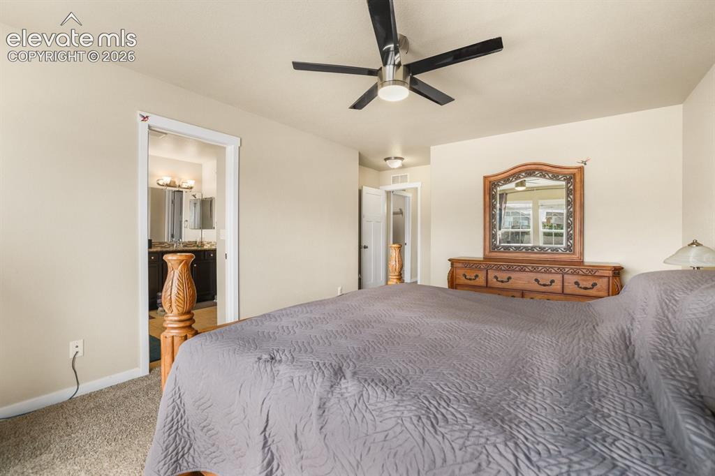 Image 37 of 44: Carpeted bedroom featuring a ceiling fan with light, recessed lighting, and