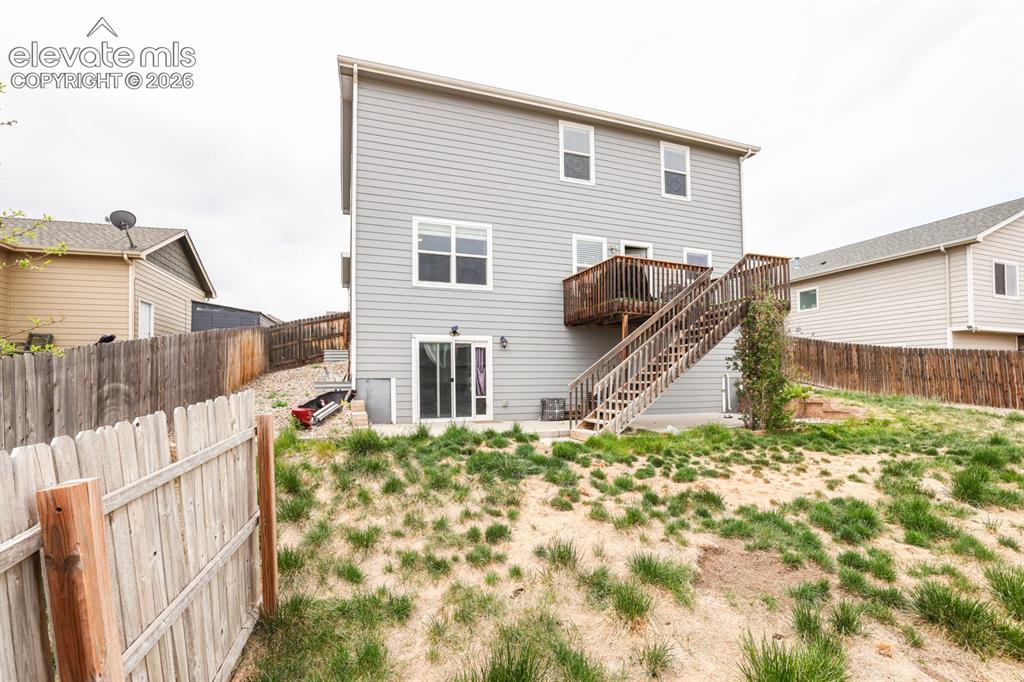 Image 4 of 44: Two-story siding exterior featuring a multi-level wooden deck with stairs t