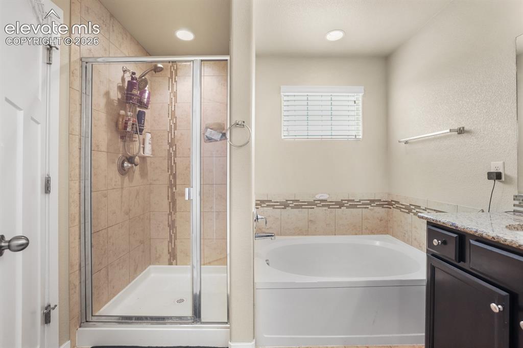 Image 41 of 44: Full bathroom featuring a walk-in shower with glass enclosure, a built-in b