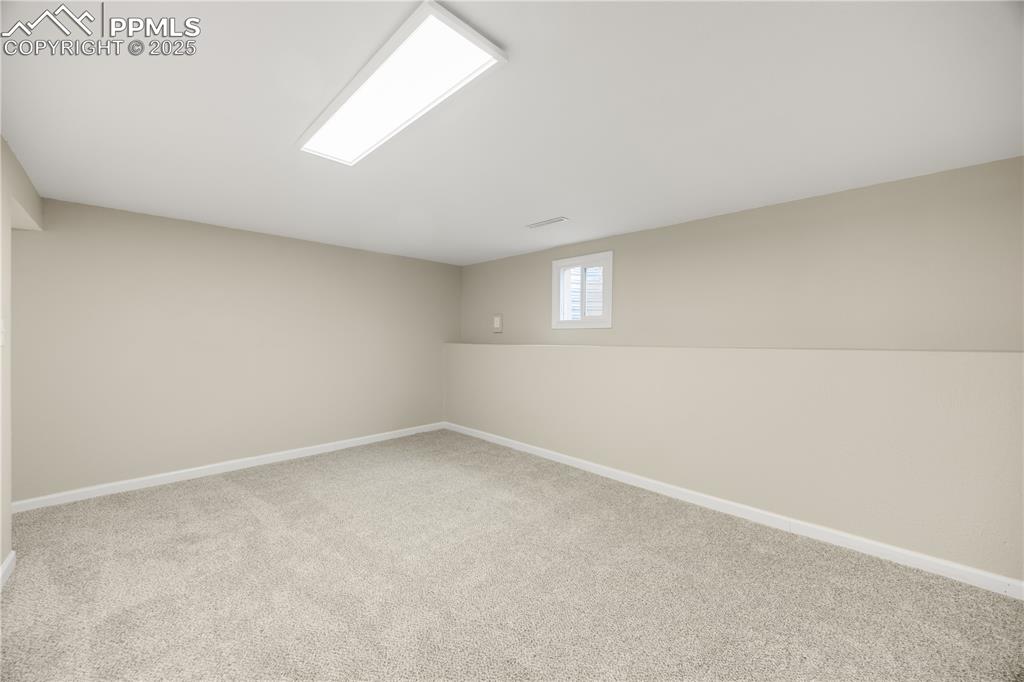 Image 27 of 36: Basement featuring carpet floors and baseboards