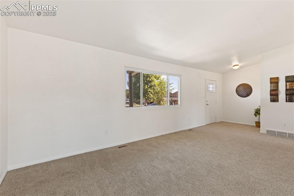 Image 12 of 44: Carpeted spare room featuring baseboards