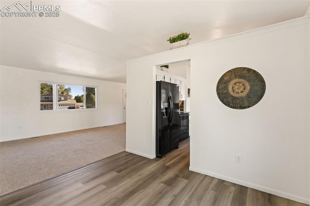 Image 16 of 44: Empty room with baseboards and dark wood finished floors