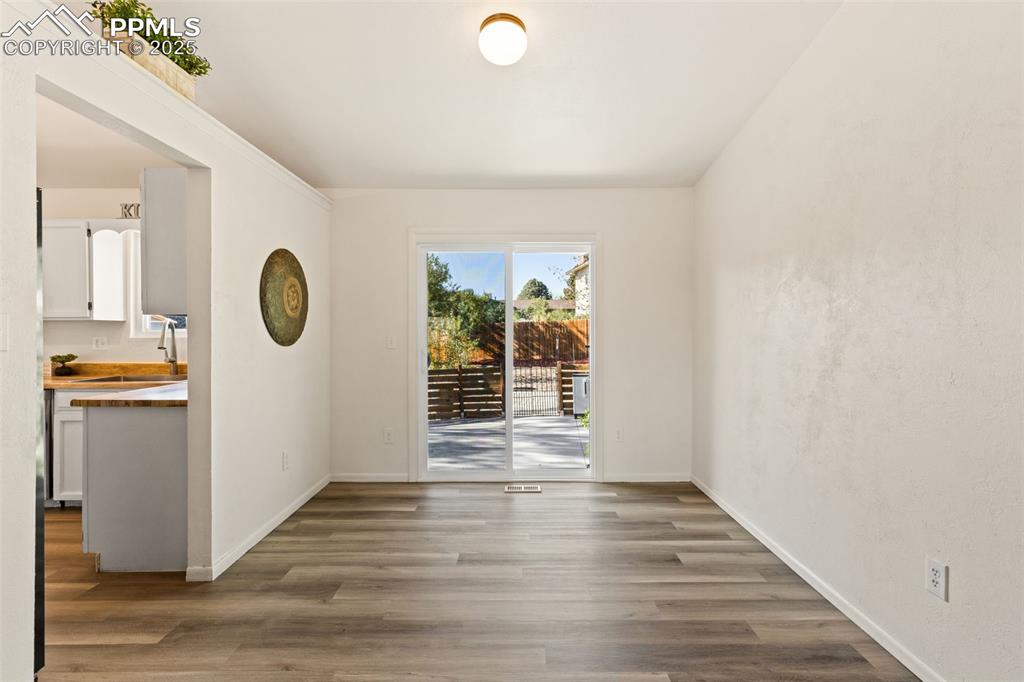 Image 17 of 44: Spare room with light wood-type flooring and a sink