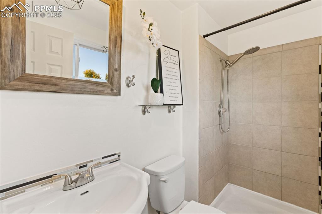 Image 26 of 44: Bathroom featuring toilet and a shower stall