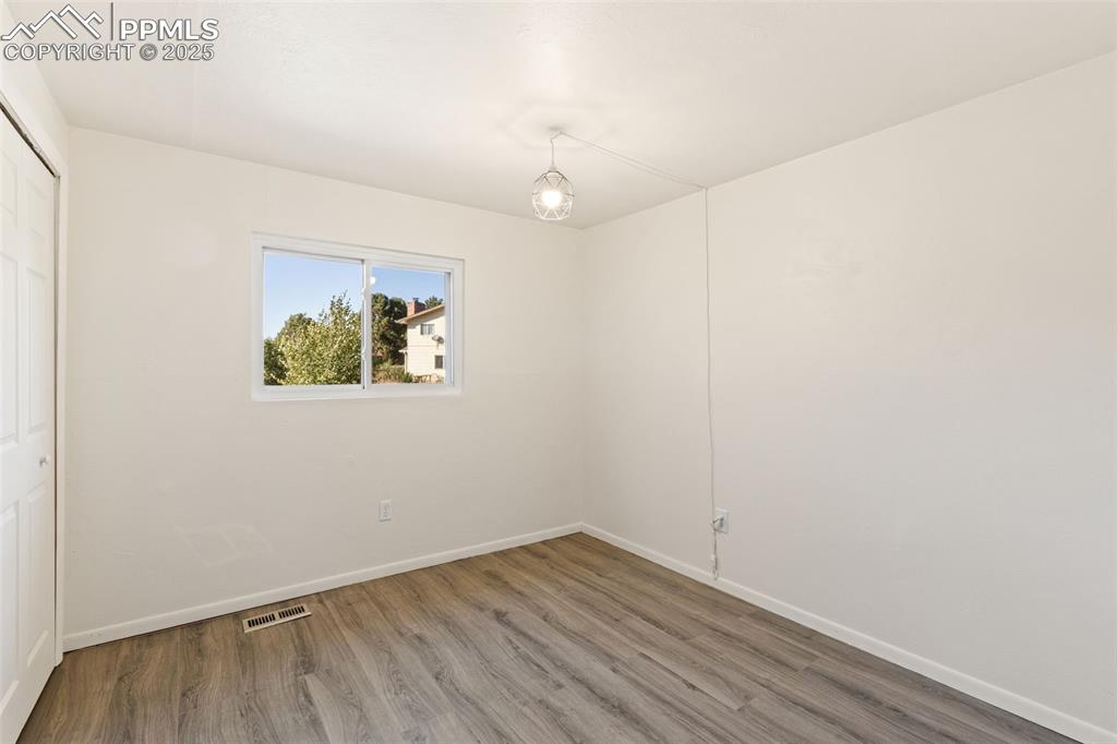 Image 27 of 44: Unfurnished bedroom featuring a closet and wood finished floors