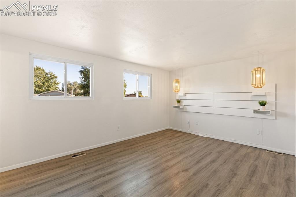 Image 29 of 44: Spare room with wood finished floors