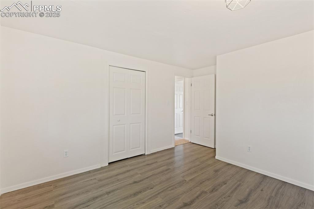 Image 32 of 44: Unfurnished bedroom featuring wood finished floors and a closet