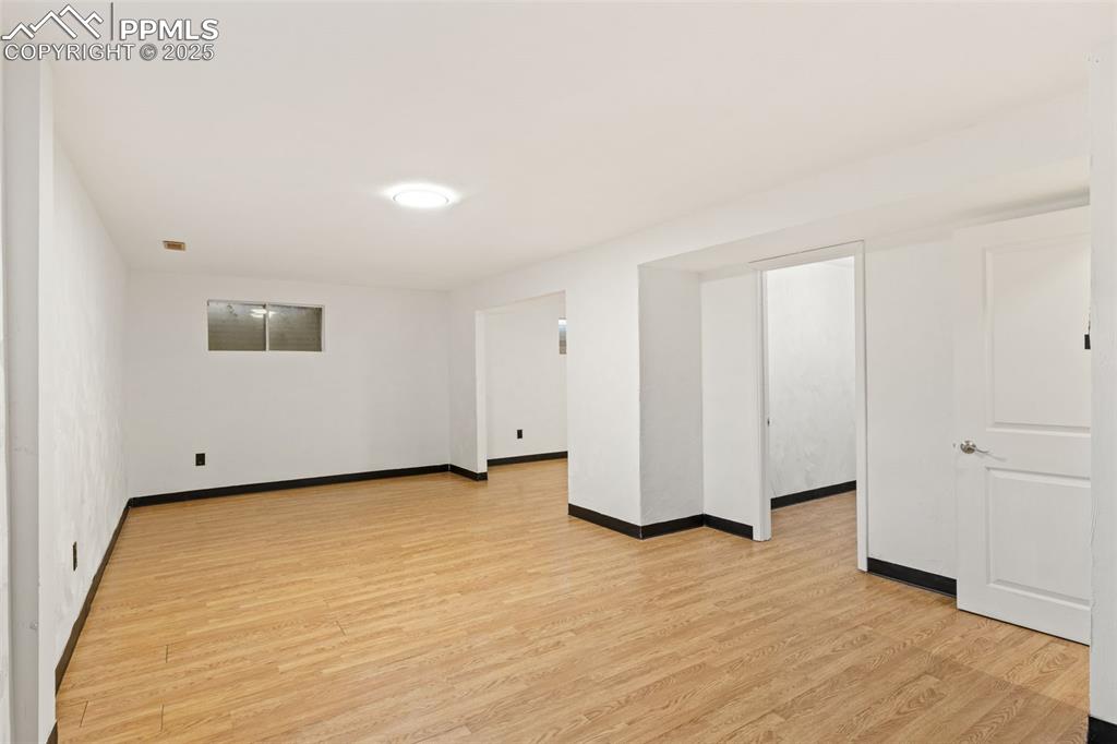 Image 37 of 44: Empty room with light wood-type flooring and baseboards