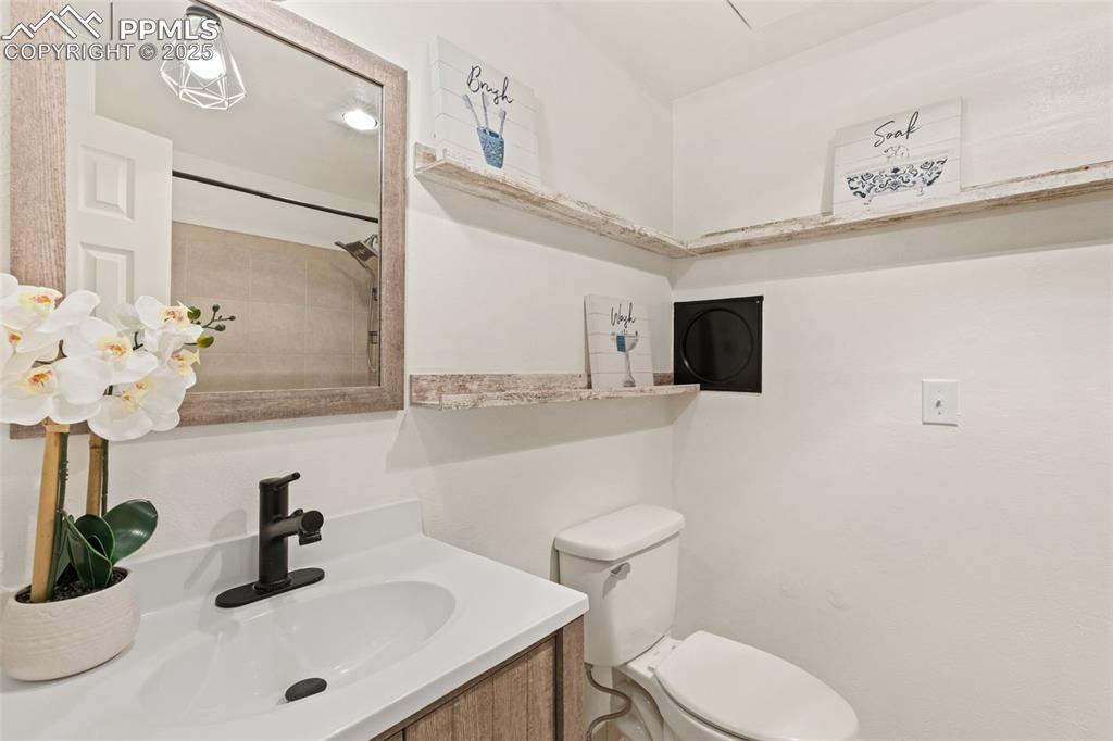 Image 39 of 44: Full bathroom with vanity and toilet
