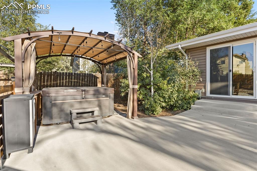 Image 41 of 44: View of patio / terrace with a hot tub