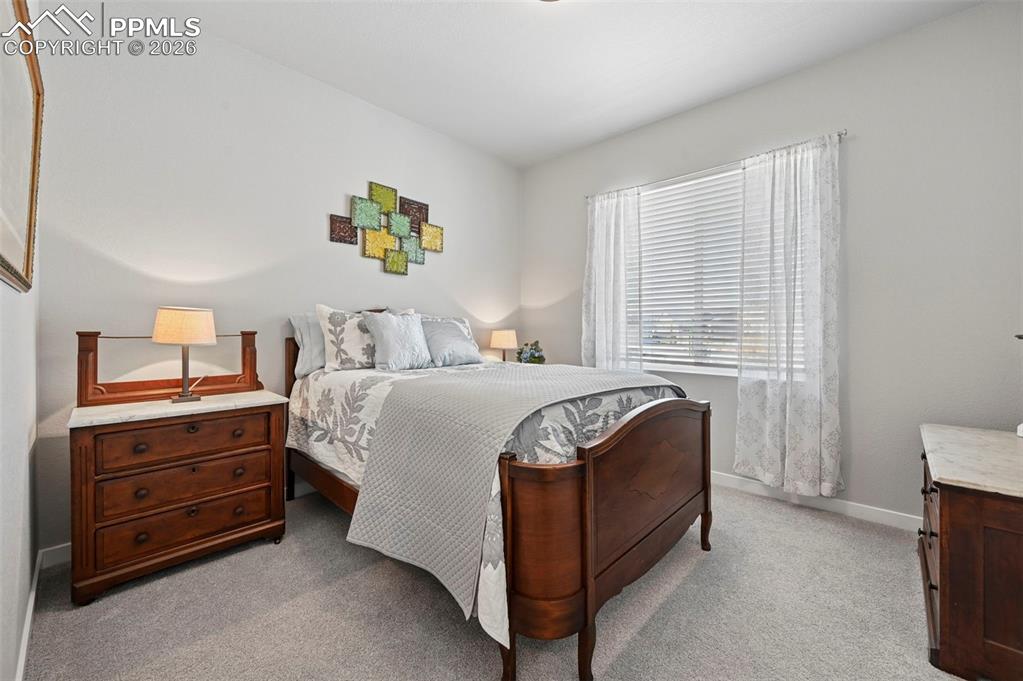 Image 26 of 49: 2nd Main Level Bedroom featuring light colored carpet and baseboards