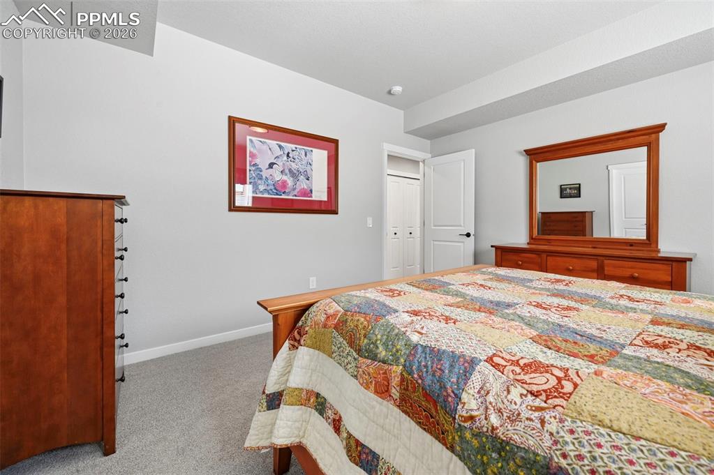 Image 36 of 49: 3rd Bedroom - Basement - featuring light carpet and baseboards