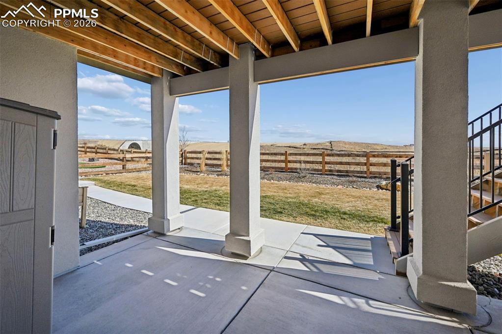 Image 43 of 49: Fenced backyard featuring a patio area and a rural view