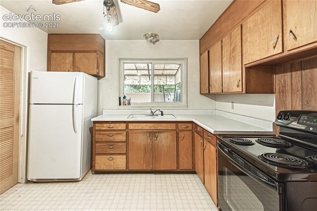 Image 11 of 44: Kitchen featuring wood-finish cabinetry, white countertops, a stainless ste