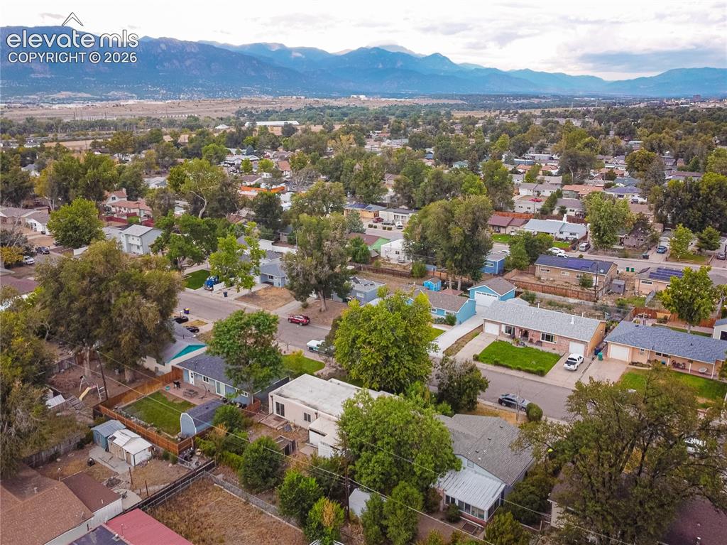 Image 41 of 44: Expansive neighborhood with mature trees, mountain backdrop, and varying ar