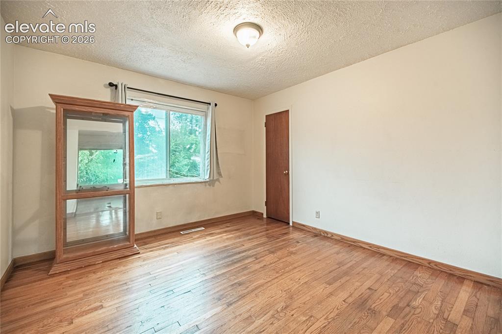 Image 8 of 44: Wood-finish flooring with a window offering natural light, a ceiling-mounte