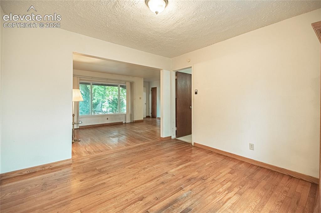 Image 9 of 44: Wood-finish flooring throughout, light-toned walls, and an expansive front