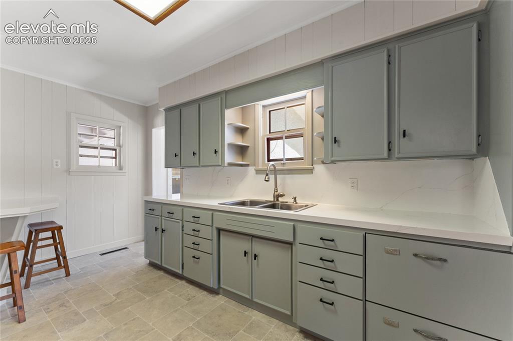 Image 12 of 39: Great counter space, double sink breakfast bar.