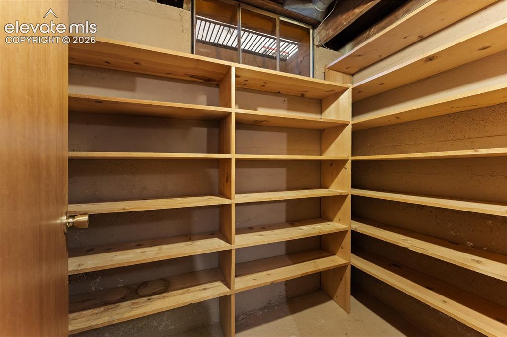 Image 24 of 39: Just opposite the laundry room is this storage room with lots of shelving