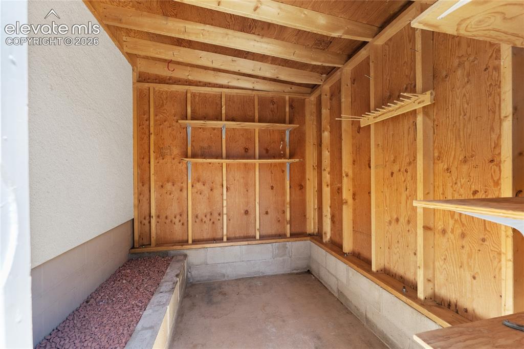 Image 30 of 39: Storage shed behind the garage plenty of room for yard tools