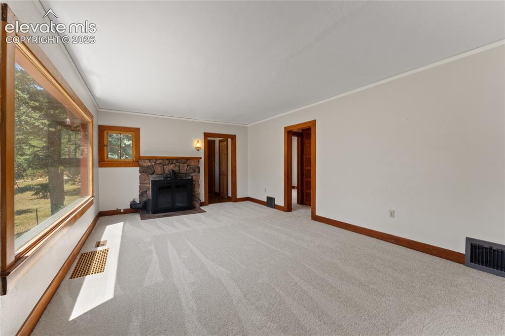 Image 8 of 38: Original stone fireplace with highly efficient heatlator