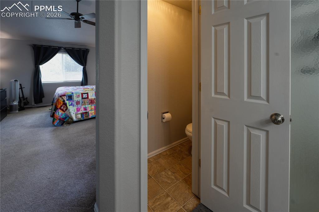 Image 17 of 45: Interior space featuring a paneled door, carpeted flooring, and a window wi