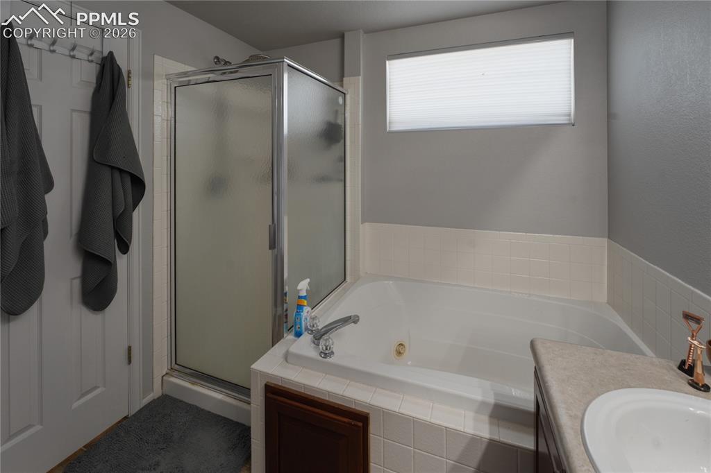 Image 21 of 45: Soaking tub with white tile surround
