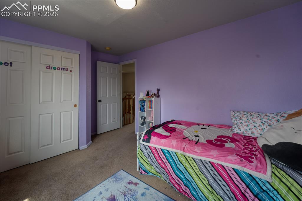 Image 24 of 45: Room featuring a light purple wall color, a white paneled bifold closet doo