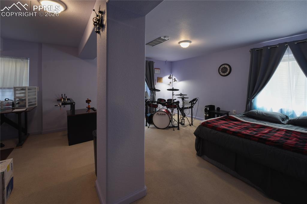 Image 31 of 45: Carpeted interior space with a partial wall separation
